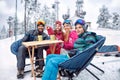 Skiing, winter fun - Family takes tea break during skiing on the Royalty Free Stock Photo